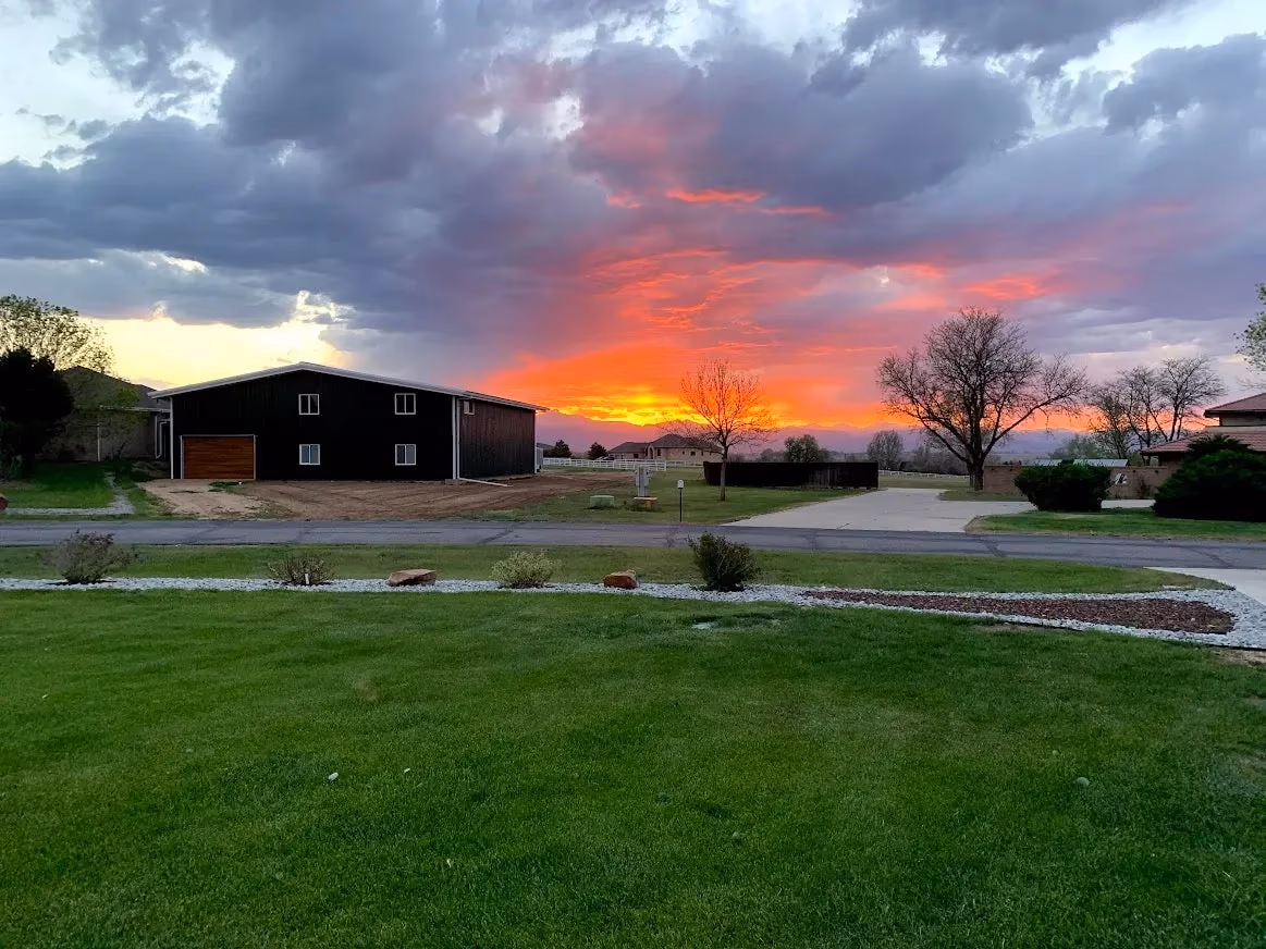 A Parkland Estates hangar at sunset under a dramatic sky.