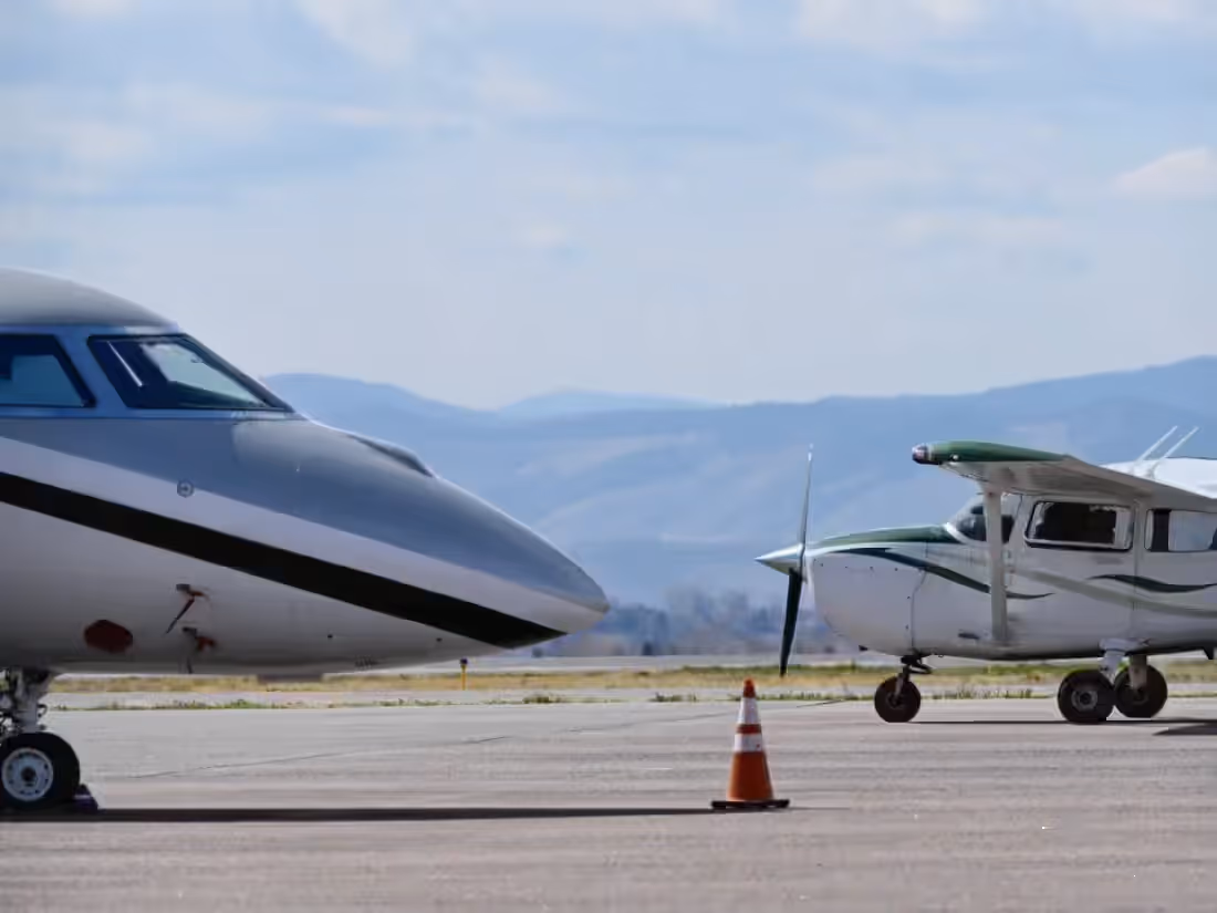 A business jet and a light single-engine aircraft parked together on a ramp