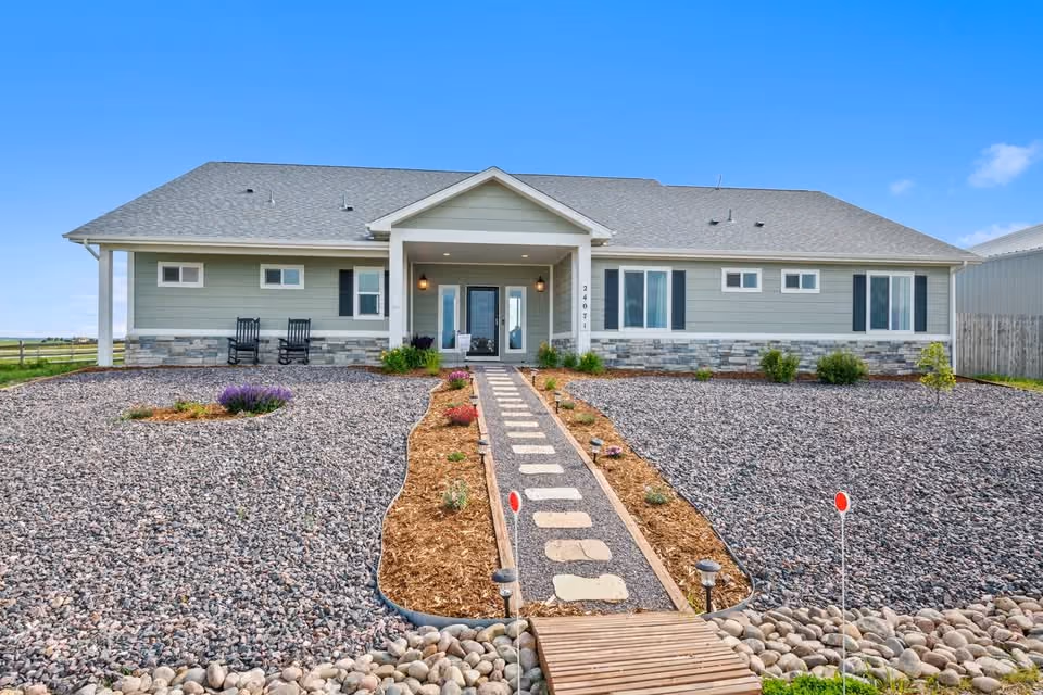 A single-story ranch home at Kelly Air Park with a stone path to the front door.